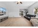 Bright living room with neutral carpet, featuring a media center and open access to other rooms at 185 S Hoyt St, Lakewood, CO 80226