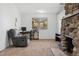 Cozy room featuring a stone fireplace with built-ins and adjacent desk area, perfect for relaxation and productivity at 185 S Hoyt St, Lakewood, CO 80226