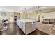 Modern kitchen featuring a large island with countertop seating, custom cabinets, and stainless-steel appliances at 2460 Eileen Way, Parker, CO 80138
