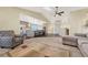 Open concept living room with a vaulted ceiling, a skylight, modern furnishings, and seamless flow to the kitchen at 2460 Eileen Way, Parker, CO 80138
