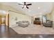 Inviting living room with vaulted ceilings, a skylight, hardwood floors, a sectional sofa and natural light at 2460 Eileen Way, Parker, CO 80138