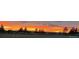 Scenic view of a colorful sunset over a pastoral landscape with trees and a distant skyline at 2460 Eileen Way, Parker, CO 80138