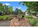 Beautiful backyard featuring a stone patio, mature trees, a fountain and professional landscaping at 1999 Champions Cir, Castle Rock, CO 80104