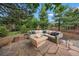 Outdoor patio featuring stone pavers, a modern fire pit, and comfortable seating at 1999 Champions Cir, Castle Rock, CO 80104