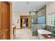 Luxurious bathroom featuring a soaking tub, a glass-enclosed shower, and a walk-in closet at 1999 Champions Cir, Castle Rock, CO 80104