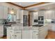 Bright kitchen featuring a large island, stainless steel appliances, granite countertops and white cabinetry at 1999 Champions Cir, Castle Rock, CO 80104