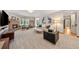 Bright living room featuring a stone fireplace, plush seating, and natural light at 1999 Champions Cir, Castle Rock, CO 80104