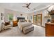 Relaxing primary bedroom with sitting area, fireplace, tray ceiling, and access to the outdoors at 1999 Champions Cir, Castle Rock, CO 80104