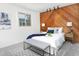 Bedroom with carpeted floors, wood accent wall, and large window at 1595 Macarthur Dr, Boulder, CO 80303