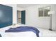 Bright bedroom featuring a blue accent door, white walls, carpet flooring and a cozy window at 1595 Macarthur Dr, Boulder, CO 80303
