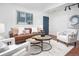 Comfortable living room featuring a leather sofa, stylish decor, and a blue accent door at 1595 Macarthur Dr, Boulder, CO 80303
