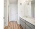 Bathroom includes double vanity, a walk in shower, and wood-look flooring at 487 Interlocken Blvd # 307, Broomfield, CO 80021