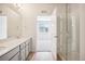 Bathroom features a double vanity and a large walk-in glass shower at 487 Interlocken Blvd # 307, Broomfield, CO 80021