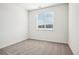 Minimalist bedroom with neutral carpet and a large window at 487 Interlocken Blvd # 307, Broomfield, CO 80021