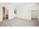 This bedroom features neutral walls and carpet and doors leading to the kitchen and closet at 487 Interlocken Blvd # 307, Broomfield, CO 80021