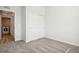 Bright bedroom features neutral carpet, closet with sliding doors, and a door leading to the laundry at 487 Interlocken Blvd # 307, Broomfield, CO 80021