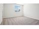 Simple bedroom featuring neutral carpet and a large window with natural light at 487 Interlocken Blvd # 307, Broomfield, CO 80021