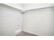 This is a walk-in closet with carpet, rods for hanging clothes, and an electrical panel at 487 Interlocken Blvd # 307, Broomfield, CO 80021
