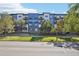 Contemporary apartment building with balconies, landscaping, and street view at 487 Interlocken Blvd # 307, Broomfield, CO 80021