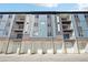 Modern apartment building exterior with private garages and balconies at 487 Interlocken Blvd # 307, Broomfield, CO 80021