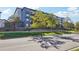 Modern apartment building with landscaping seen from the street on a sunny day at 487 Interlocken Blvd # 307, Broomfield, CO 80021