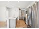 Bright kitchen with stainless steel appliances, white countertops and cabinets, and hardwood floors at 487 Interlocken Blvd # 307, Broomfield, CO 80021
