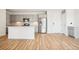 Spacious kitchen with stainless steel appliances, subway tile backsplash, and a center island with quartz countertops at 487 Interlocken Blvd # 307, Broomfield, CO 80021