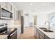 Bright kitchen with stainless steel appliances, white countertops, ample cabinet space, and hardwood floors at 487 Interlocken Blvd # 307, Broomfield, CO 80021