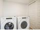Laundry room includes a side by side Whirlpool washer and dryer and a closet with sliding doors at 487 Interlocken Blvd # 307, Broomfield, CO 80021