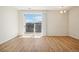 Spacious living room with wood floors, balcony access, and lots of natural light at 487 Interlocken Blvd # 307, Broomfield, CO 80021