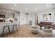 Open living space featuring modern decor, light wood floors, and a sleek kitchen island with bar stool seating at 487 Interlocken Blvd # 307, Broomfield, CO 80021