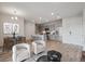 Open concept living room with modern kitchen, dining area, and stylish furnishings at 487 Interlocken Blvd # 307, Broomfield, CO 80021
