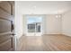 Bright living room with wood floors, door, and a view of the neighborhood at 487 Interlocken Blvd # 307, Broomfield, CO 80021