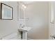 Small bathroom featuring white fixtures, mirror, and light fixture at 2582 Beech Ct, Golden, CO 80401