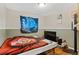 Bedroom featuring a bed, a small television, and a sports blanket at 2582 Beech Ct, Golden, CO 80401