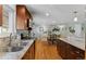 Open kitchen layout with wooden cabinets, granite counters, stainless appliances, and hardwood flooring at 2582 Beech Ct, Golden, CO 80401