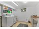 Functional laundry room with modern washer and dryer, cabinet space, and tile flooring at 2582 Beech Ct, Golden, CO 80401