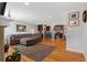Open concept living room featuring a large sofa, hardwood floors, and updated kitchen at 2582 Beech Ct, Golden, CO 80401