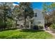 Large backyard showcasing a covered patio, mature trees, and a well-maintained lawn at 7076 S Niagara Ct, Centennial, CO 80112