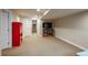 Open finished basement area with neutral carpet, recessed lighting, and access to the stairs at 7076 S Niagara Ct, Centennial, CO 80112