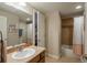 Well-lit bathroom with a single vanity, tiled shower, and a large framed mirror at 7076 S Niagara Ct, Centennial, CO 80112