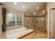 Bright bathroom featuring a soaking tub, glass shower, and decorative tilework at 7076 S Niagara Ct, Centennial, CO 80112