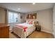 Cozy bedroom with a bright window, comfortable queen bed, and ample natural light at 7076 S Niagara Ct, Centennial, CO 80112