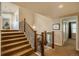 Hallway with wooden staircase, carpeted floors, chandelier and neutral wall paint at 7076 S Niagara Ct, Centennial, CO 80112