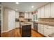 Bright kitchen boasts stainless appliances, granite countertops, and custom cabinetry with an island, perfect for cooking at 7076 S Niagara Ct, Centennial, CO 80112