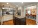 Open-concept kitchen showcasing granite counters, stainless steel appliances, a central island, and seamless access to dining area at 7076 S Niagara Ct, Centennial, CO 80112