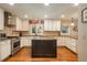 Well-equipped kitchen with stainless steel appliances, granite countertops, and custom cabinets, centered by an island at 7076 S Niagara Ct, Centennial, CO 80112