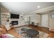 Comfortable living room featuring a fireplace, hardwood floors, and built-in shelving at 7076 S Niagara Ct, Centennial, CO 80112
