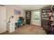 Spacious home office featuring built-in bookshelves, a comfortable workspace, and natural light at 7076 S Niagara Ct, Centennial, CO 80112