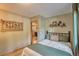 Cozy bedroom with a full-sized bed, decorative accents and a doorway view into the kitchen at 609 Brook Dr, Idaho Springs, CO 80452